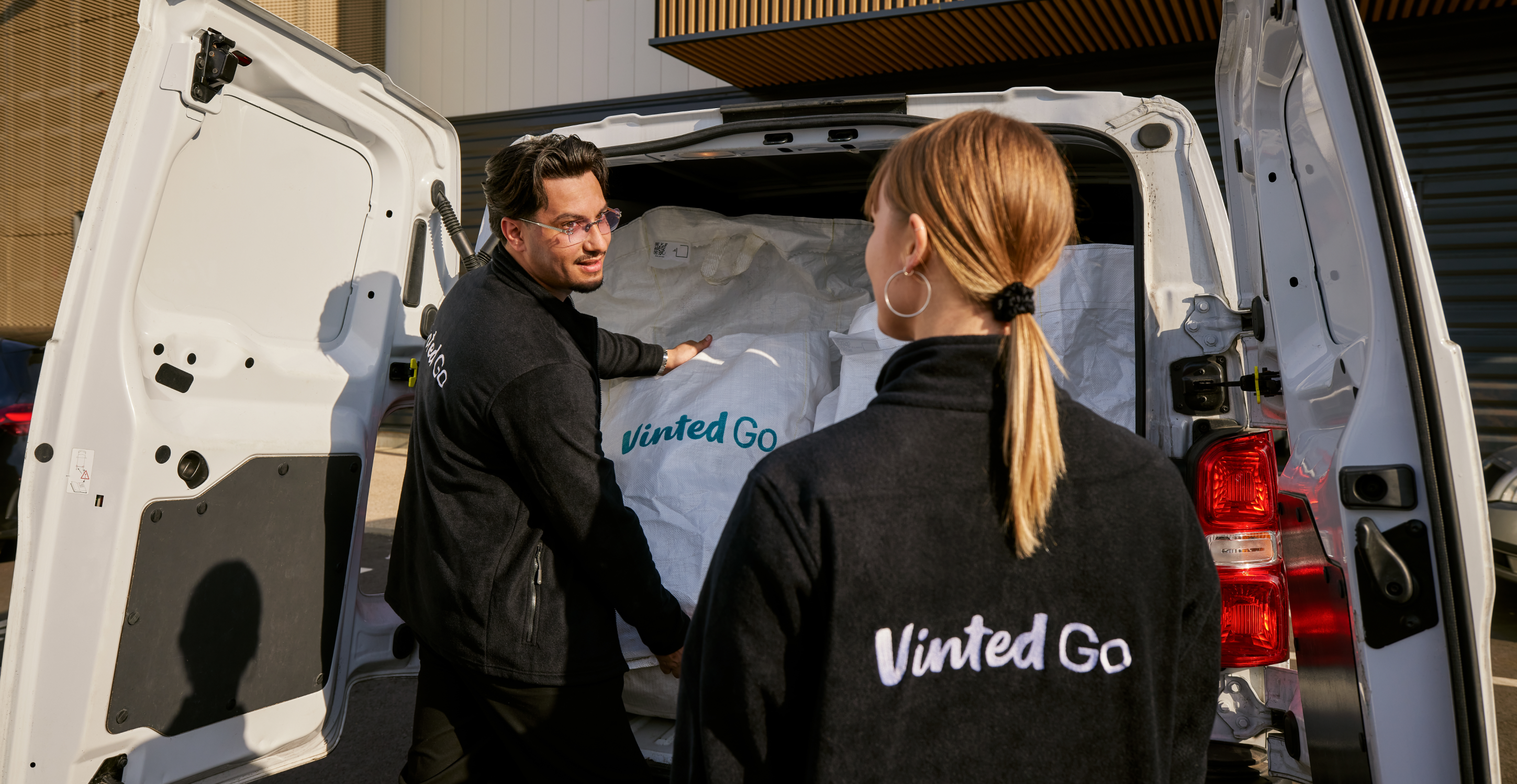 A vintedGo driver putting bags into a truck