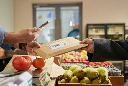 A shop scanning a parcel from a customer