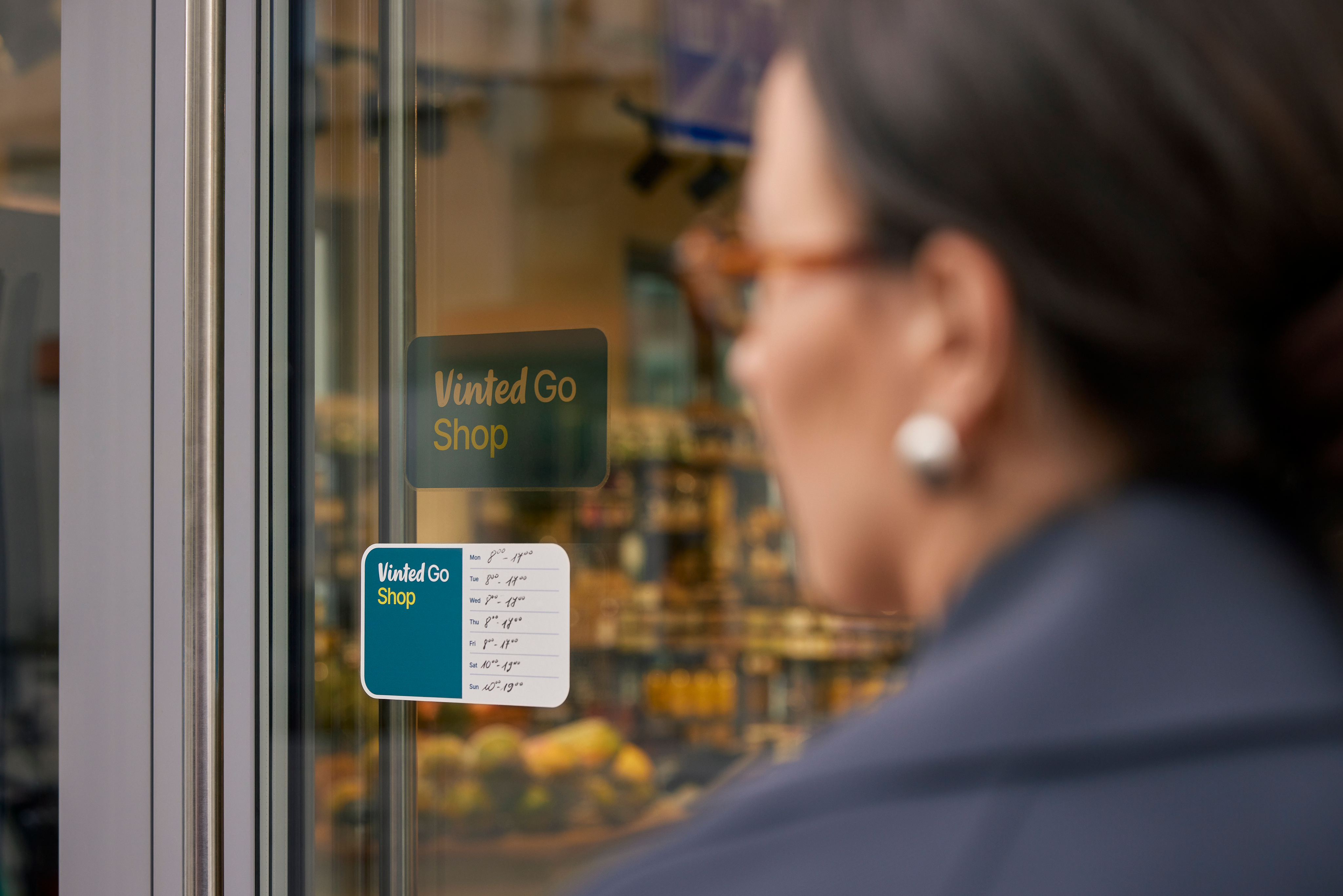 A person walking by a open vintedgo shop